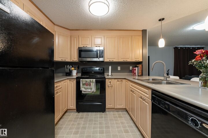 Property Photo: 6220 134 Avenue NW 101 AB T5A 0A8