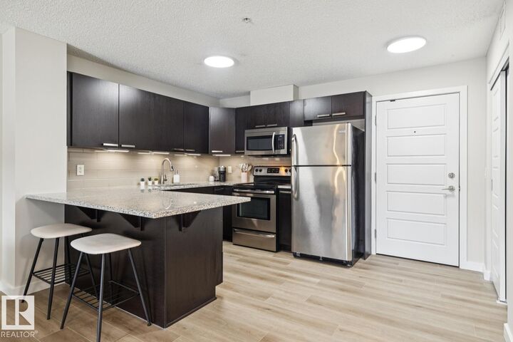 Property Photo:  14808 125 Street NW 206  AB T5X 0G1 